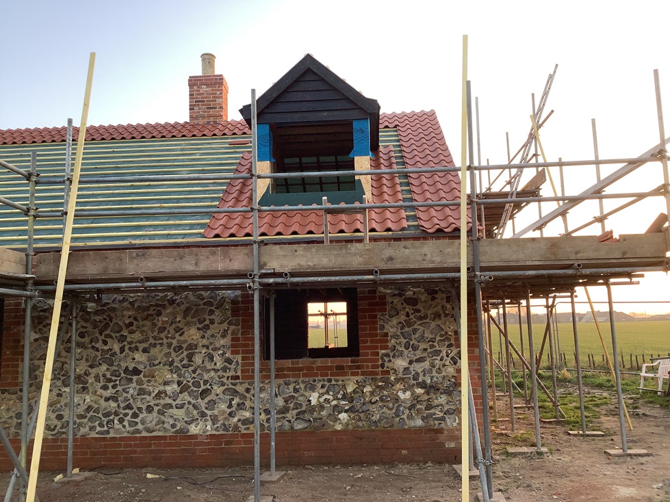 kraft_rebuild - Roof tiles being laid